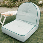 Reclining pillow lounger in a garden setting
