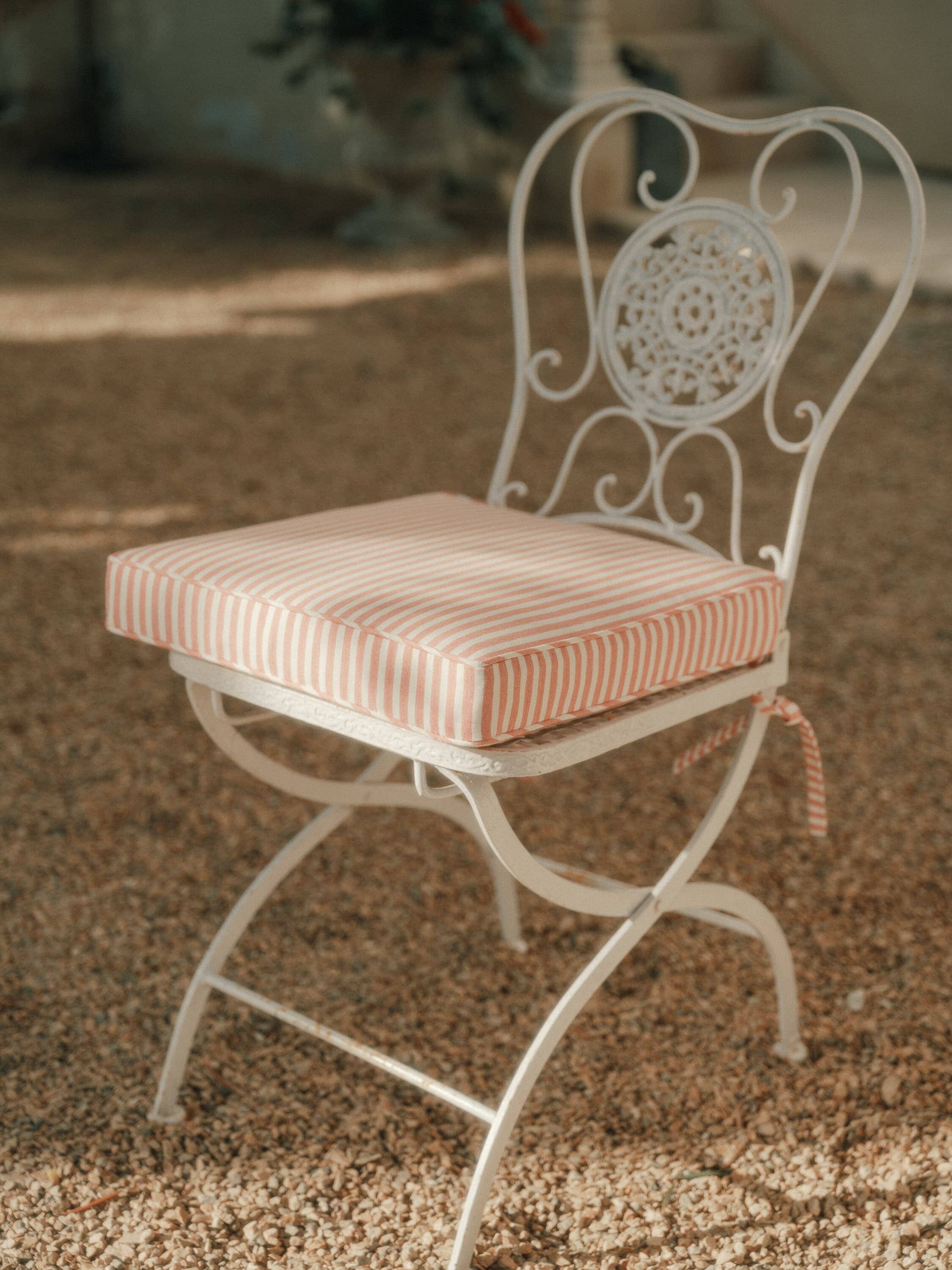 pink seat pillow on metal frame chair