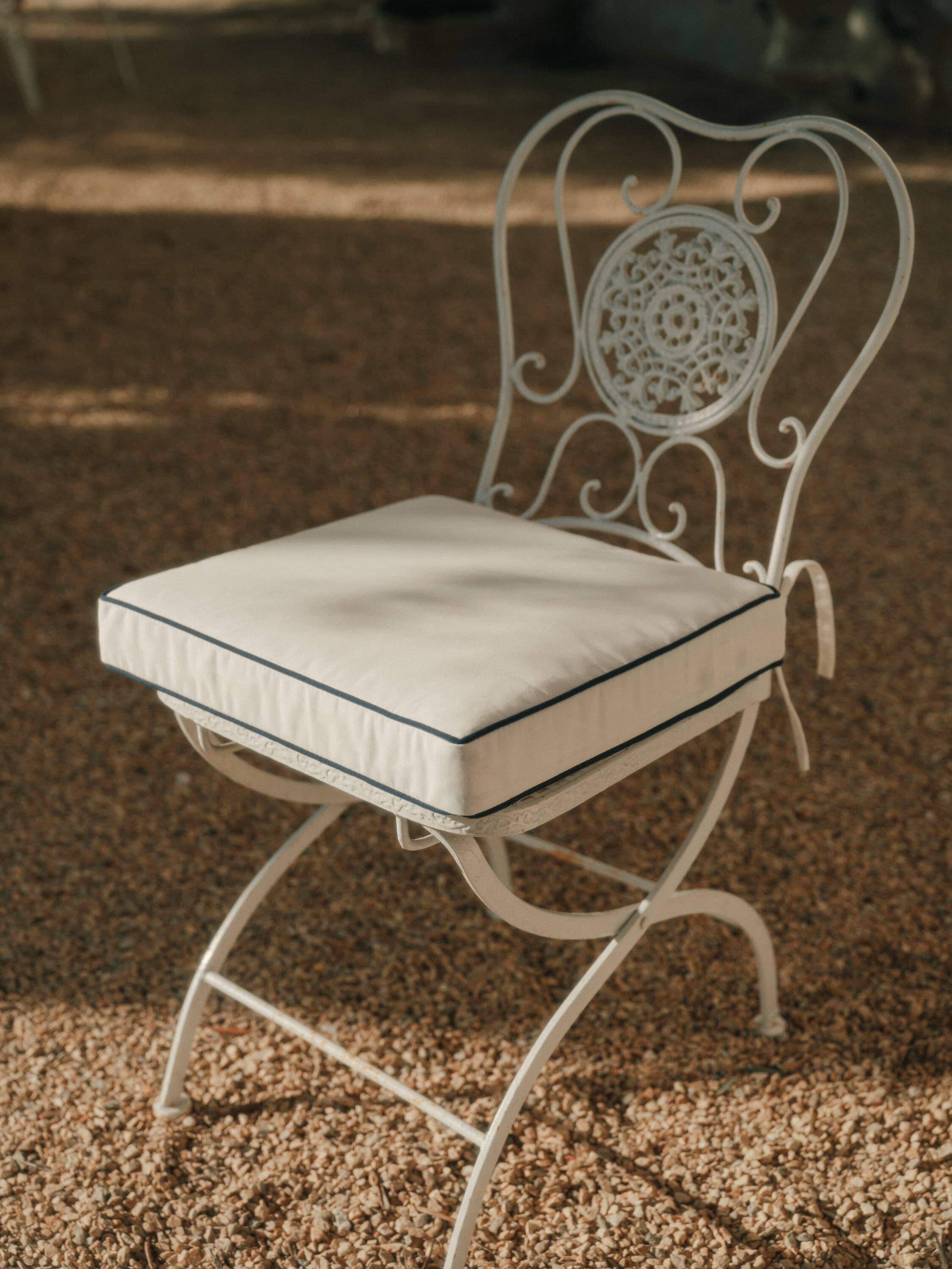 white seat pillow on metal frame chair
