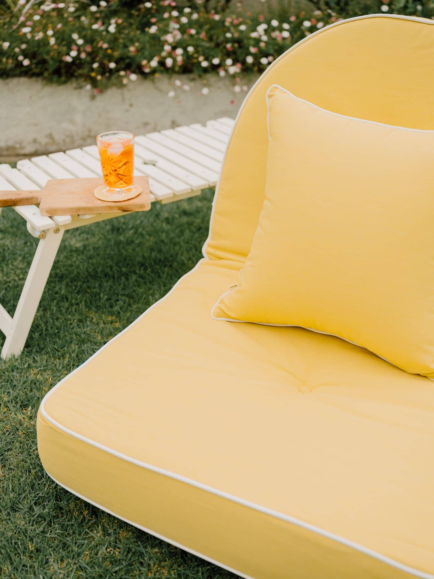 Riviera mimosa small throw pillow on an outdoor pillow lounger