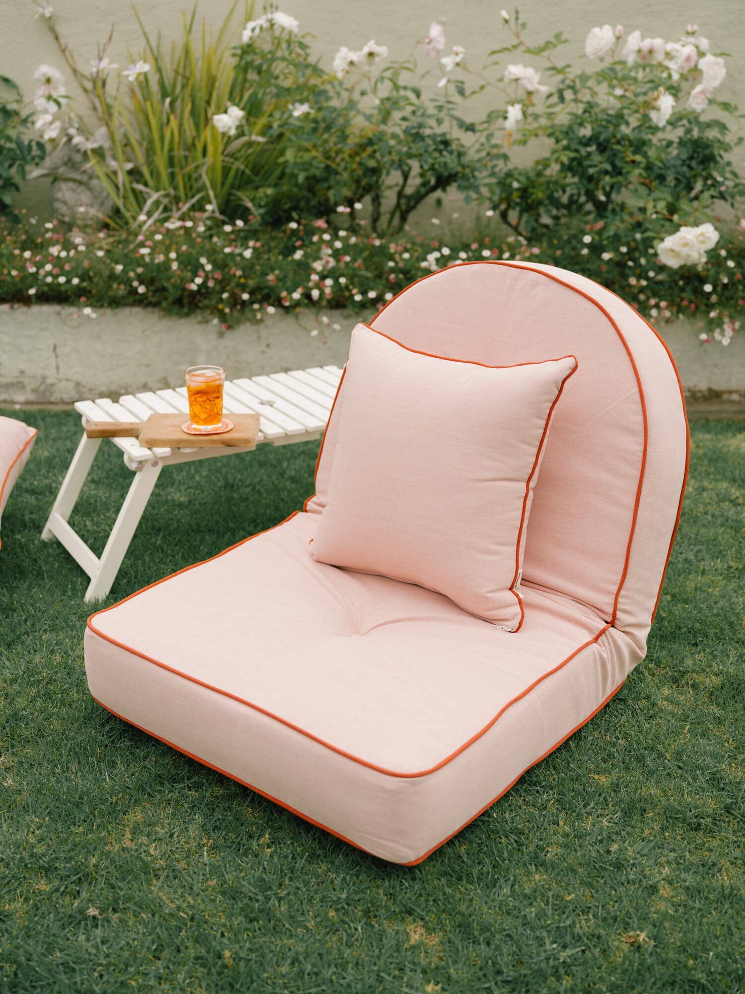 Riviera pink small throw pillow on an outdoor lounger