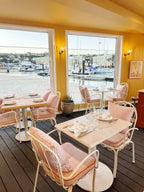Al fresco chair in a restaurant with cushion and small square cushion