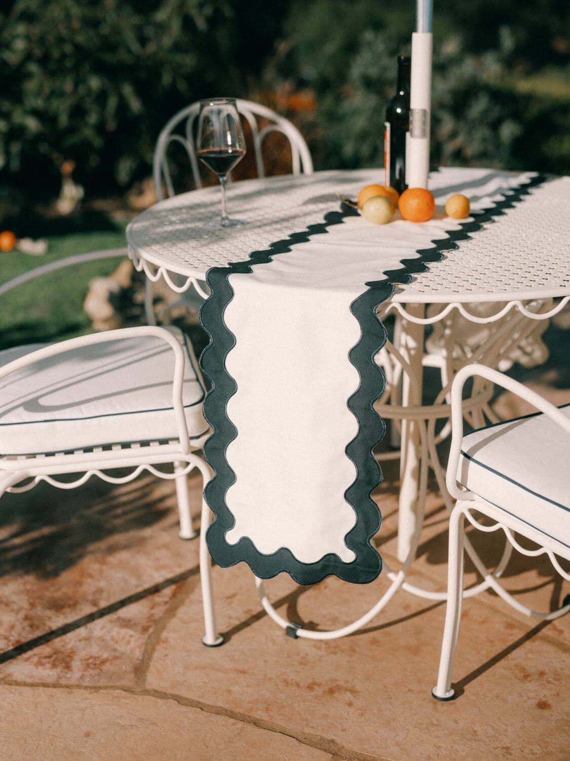 riviera white table runner draped over an outdoor table