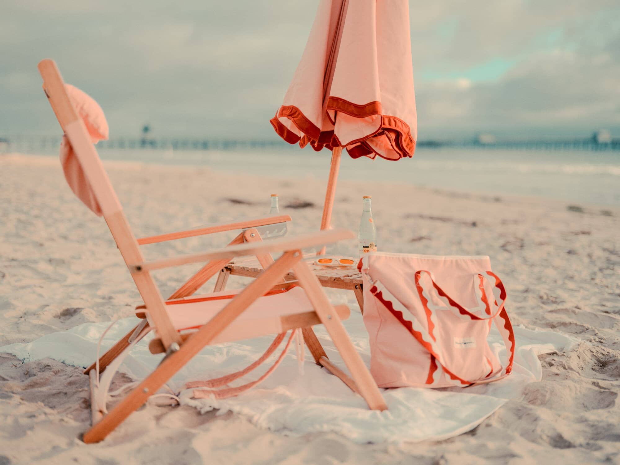 Rivie pink beach set up with chair, umbrella and cooler