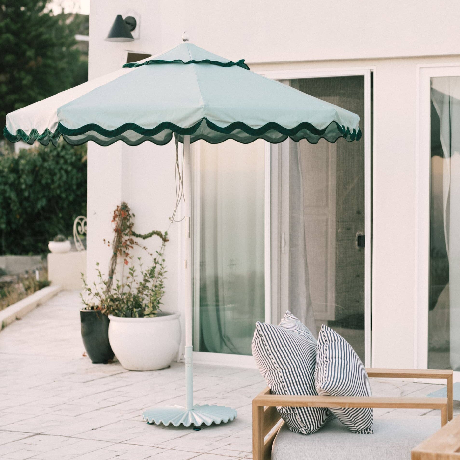 Wide view of Sage Green Base and Green Market Umbrella on a patio