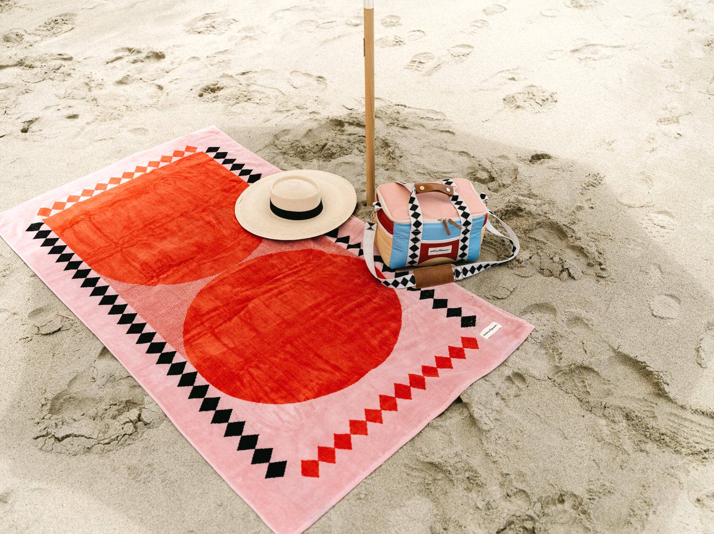 pink diamond cooler and towel on the beach