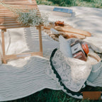Picnic setting with riviera green cooler, sage blanket & folding table