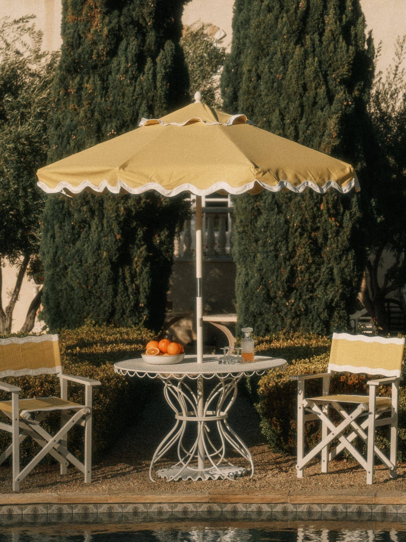 outdoor setting with riviera mimosa market umbrella and directors chairs