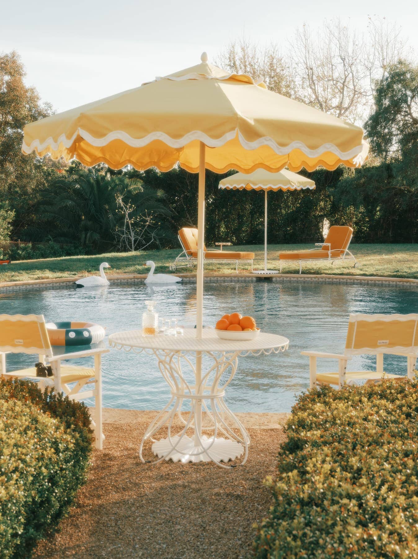 pool setting with riviera mimosa market umbrella and directors chairs