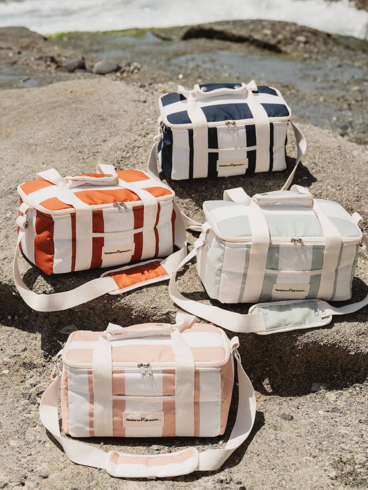 holiday cooler bags on the rocks at the beach