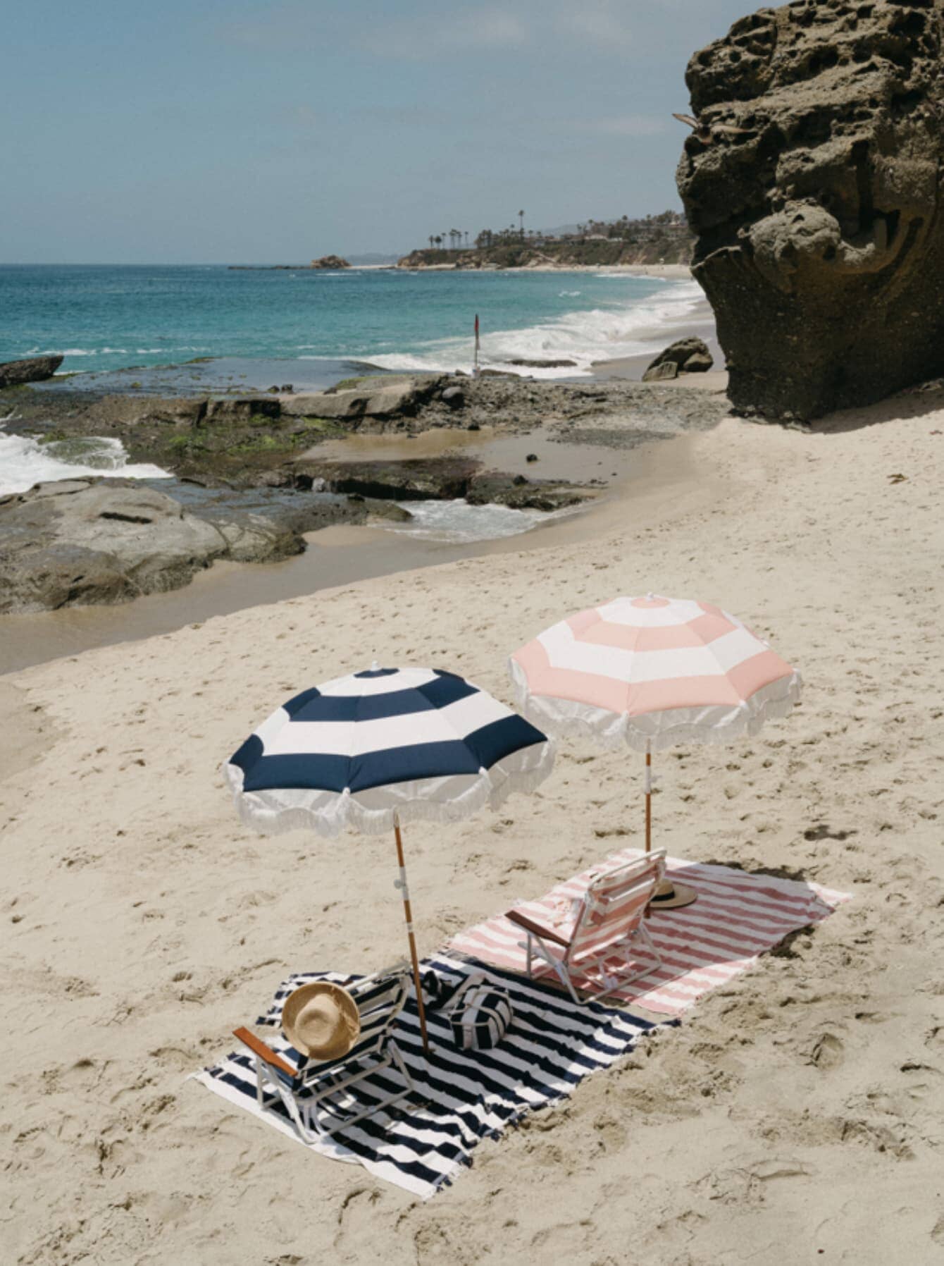 pink and navy holiday umbrella on the beach