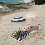 pink and navy holiday umbrella on the beach