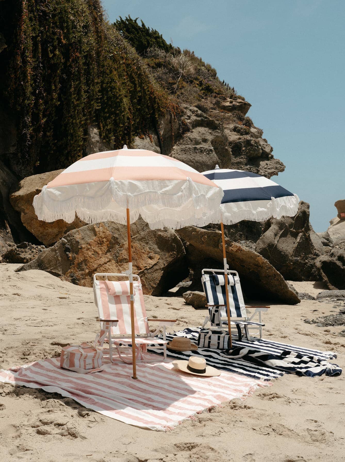 pink and navy holiday umbrellas on the beach