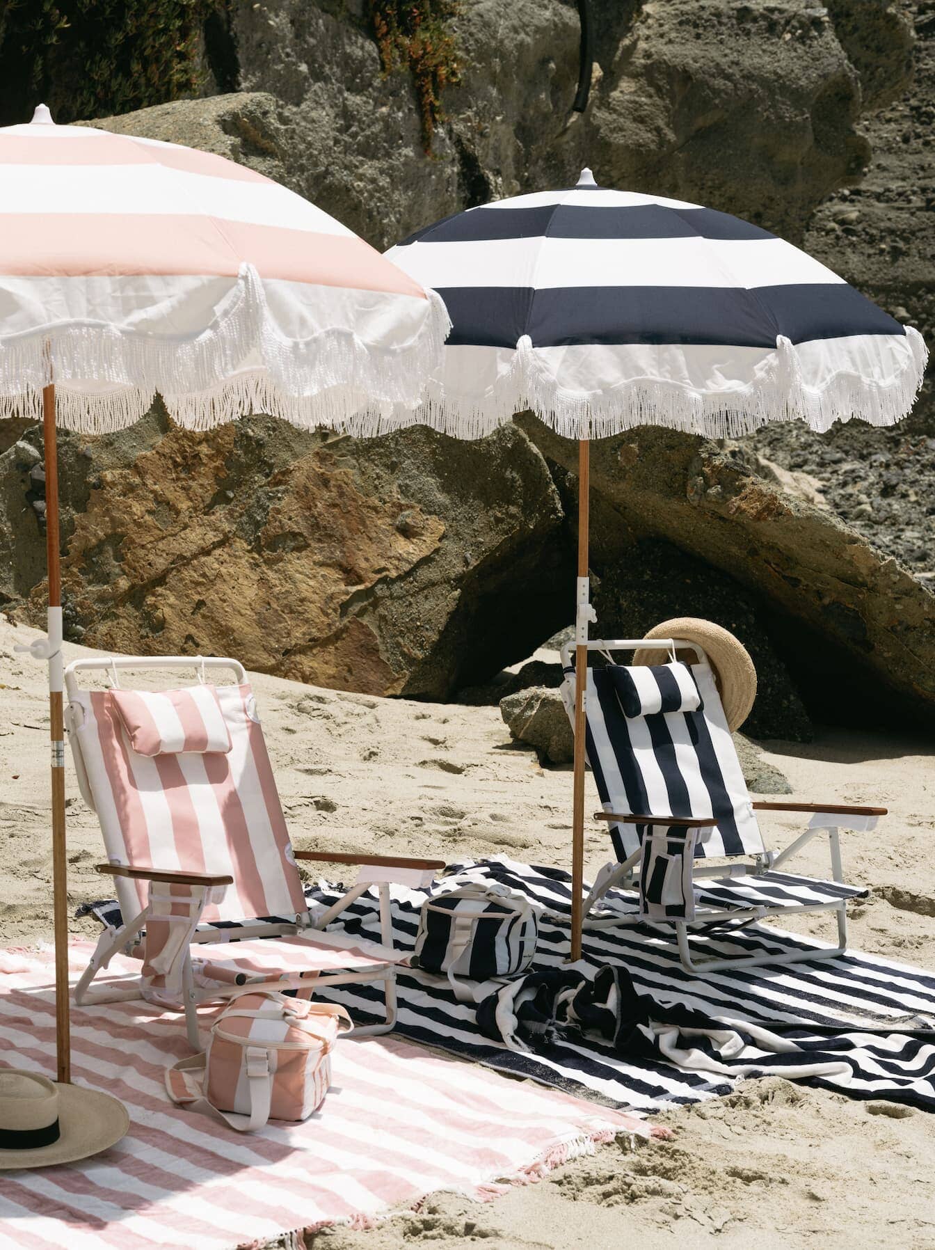 navy and pink holiday tommy chairs and umbrellas on a beach
