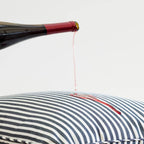 Studio image of red wine being poured on the pillow