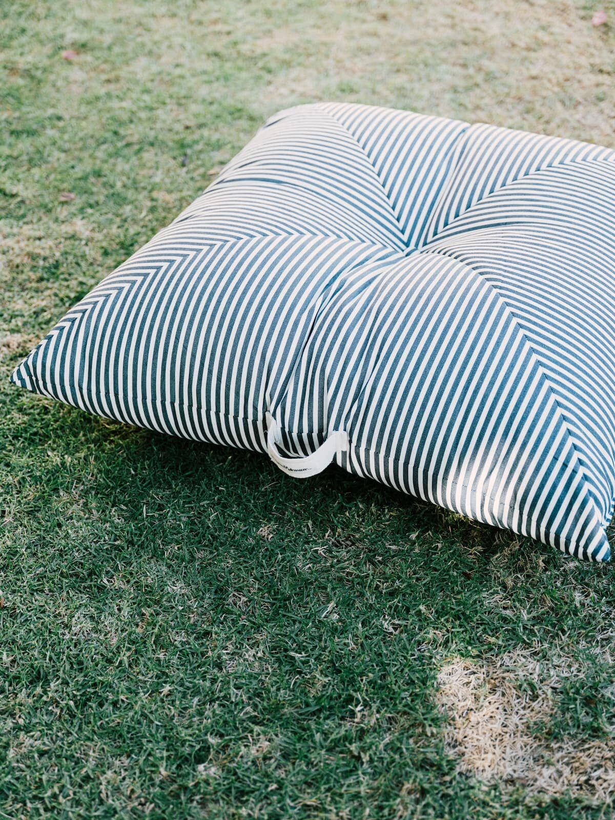 Lifestyle image of floor pillow on the grass