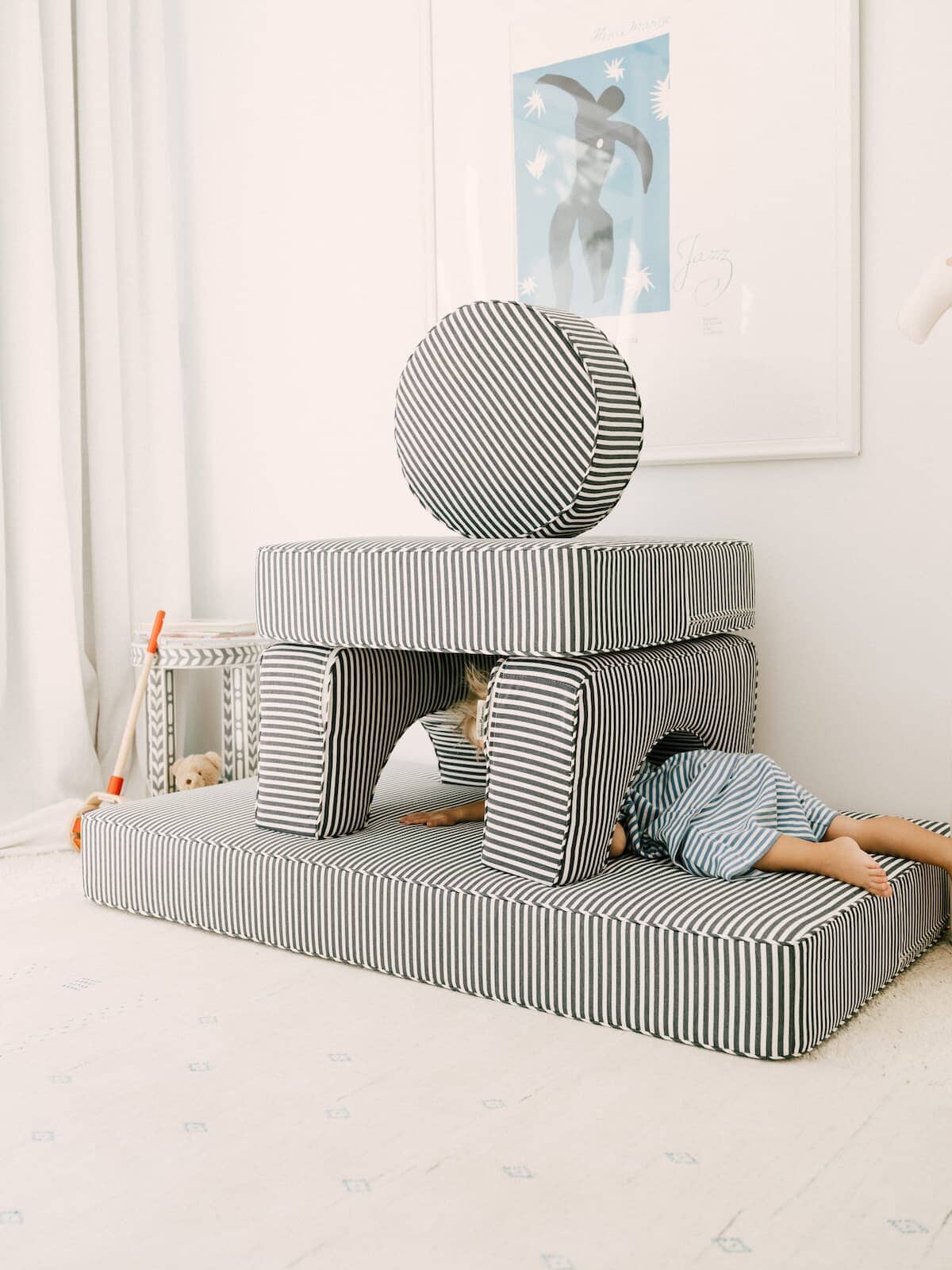 A child climbing through the stacked modular pillow stack
