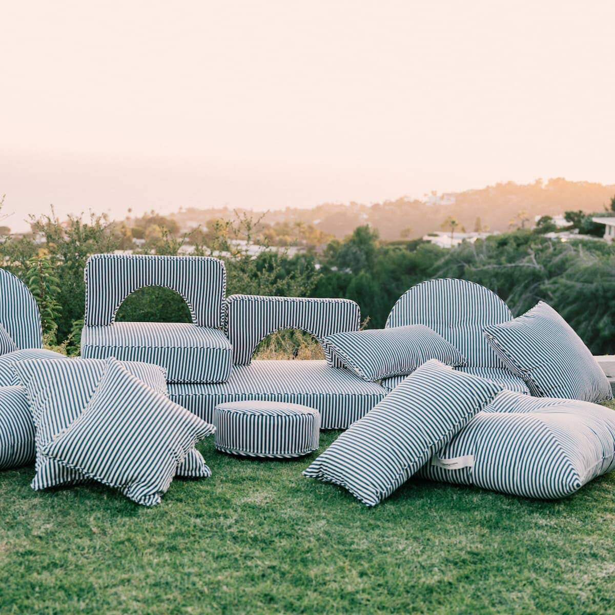 Outdoor image of the entire outdoor cushion collection on the grass