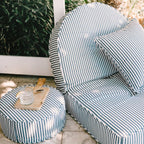Lifestyle image of the reclining lounger on a patio with a drink