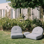 Lifestyle image of 2 reclining loungers in a garden setting