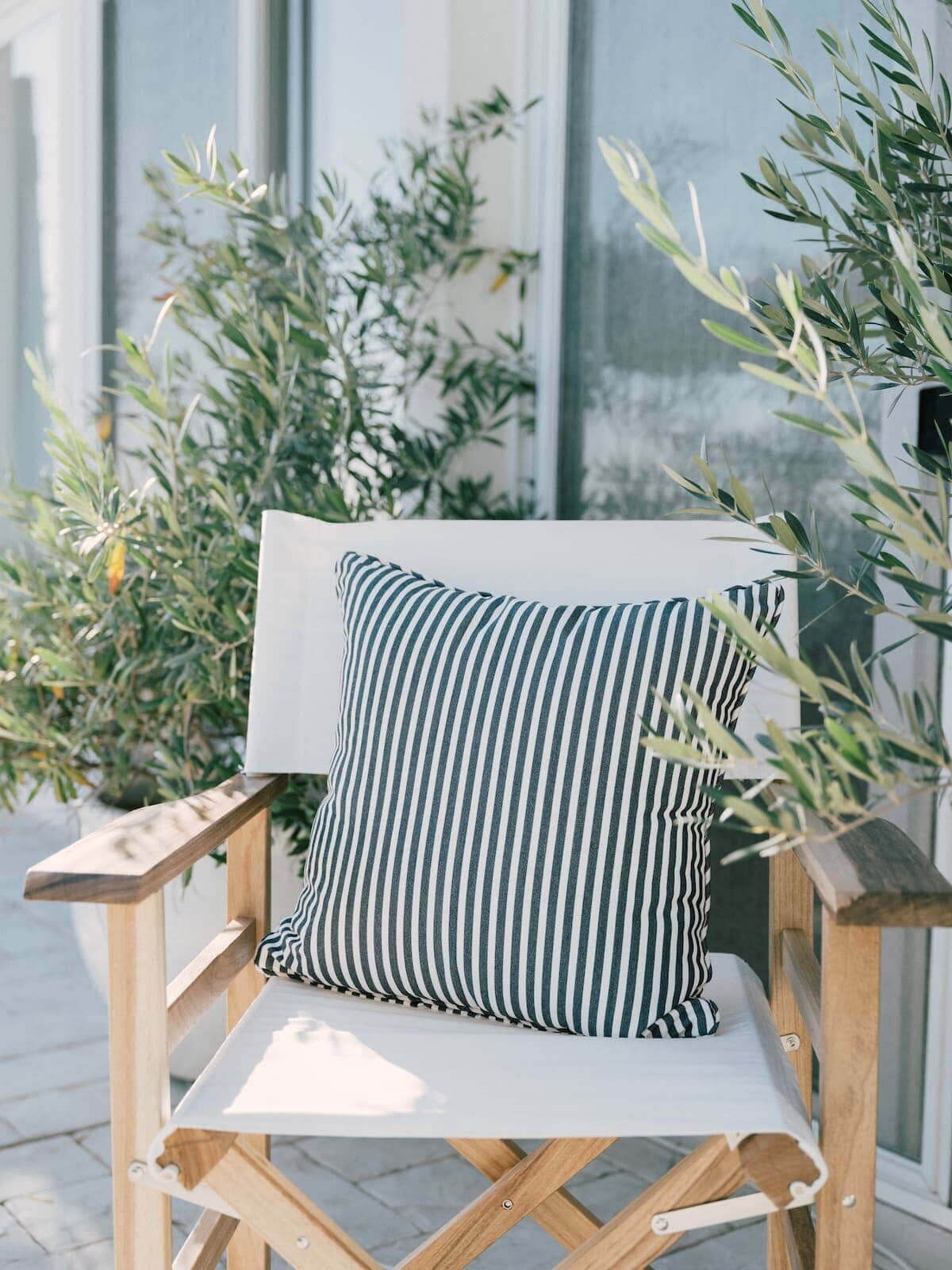 navy stripe small square throw pillow on a directors chair