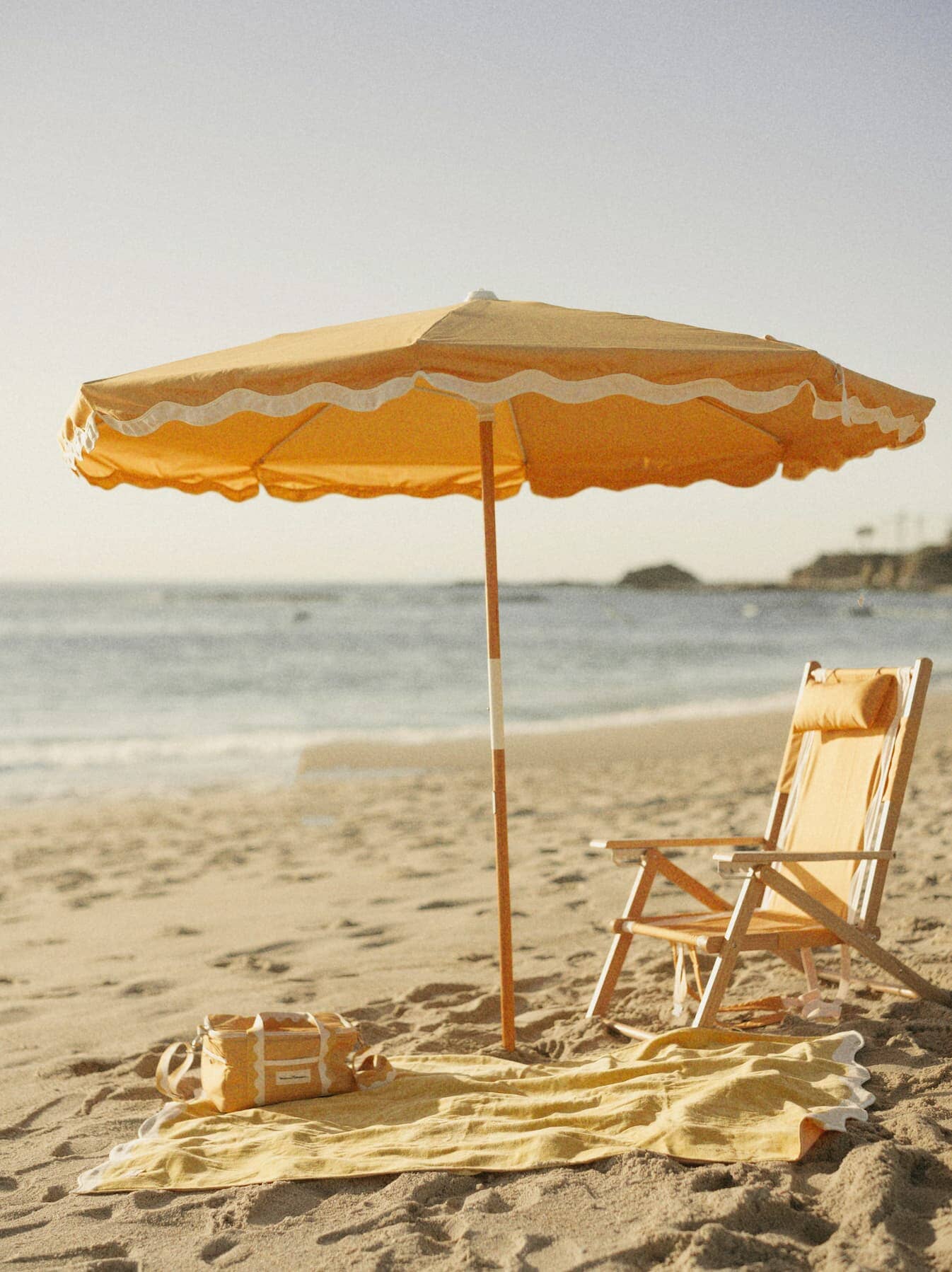 Beach setting with Riviera mimosa umbrella, chair, towel & cooler