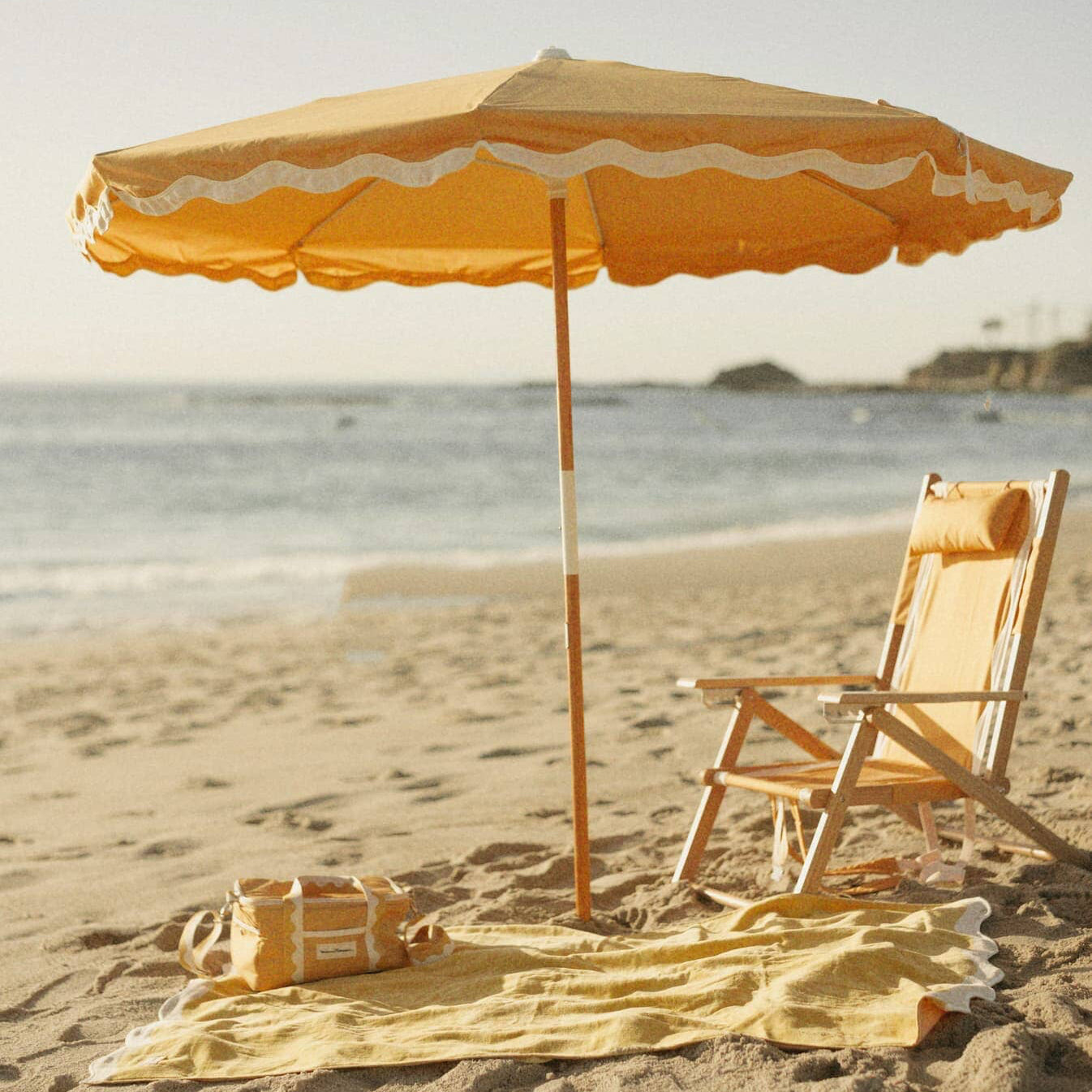 Beach setting with Riviera mimosa umbrella, chair, towel & cooler