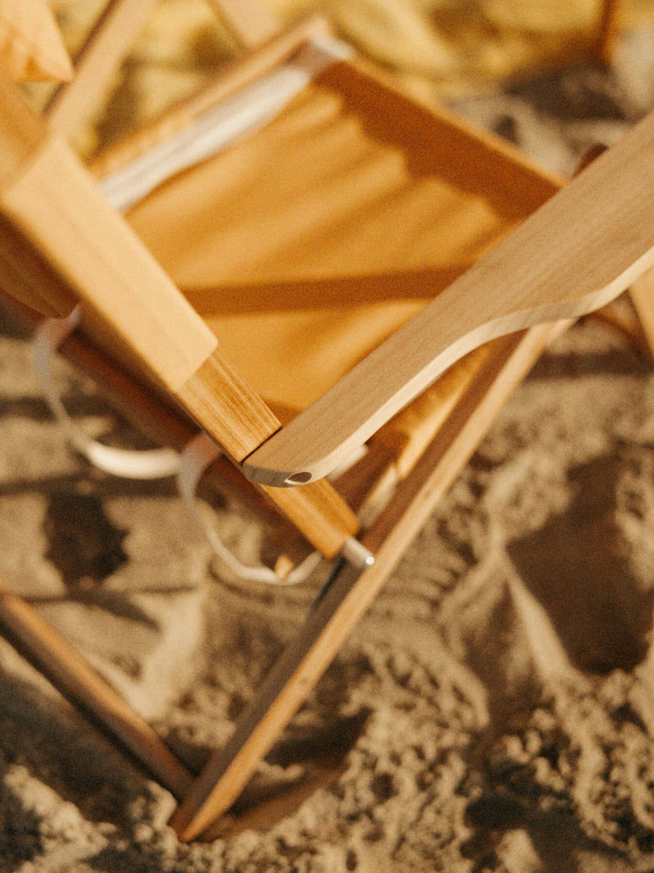 Close up shot of riviera mimosa tommy chair on the sand