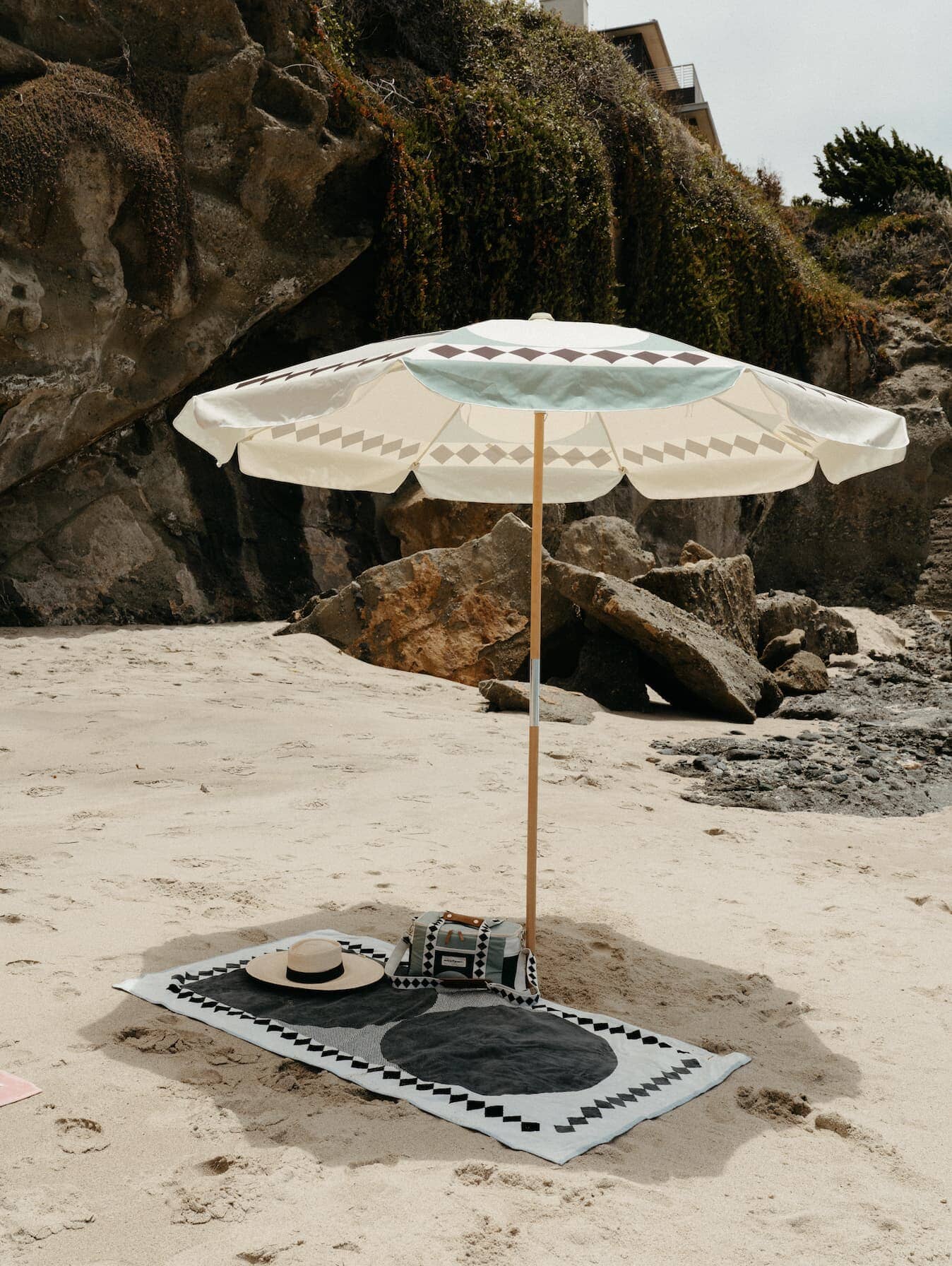 Diamond green amalfi umbrella, beach towel, cooler bag and hat at a beach