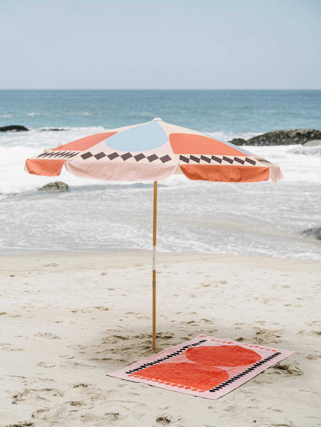 diamond pink amalfi umbrella and beach towel on the beacj